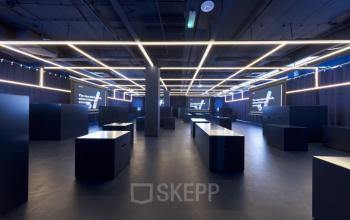 Sleek, modern open floor plan at Europalaan 100, Utrecht Kanaleneiland, featuring minimalistic dark interiors and illuminated grid lighting, ideal for office space rental.