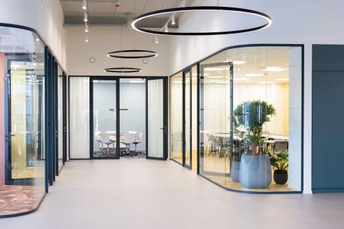 Contemporary office space at Atoomweg 50, Utrecht Lage Weide, featuring sleek glass walls and plants, ideal for office space rental.