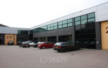 Exterior view of the office building located at Atoomweg 280-282, Utrecht Lage Weide, Utrecht, showing a modern facade with large windows and parked cars in the lot.