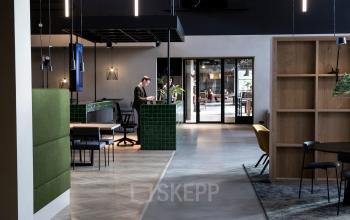 Stylish office space at Atoomweg 63, Utrecht Lage Weide, featuring a modern interior with people engaged in business activities. Ideal for office space rental with contemporary furnishings and functional design.