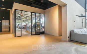 Modern office space in Utrecht Lage Weide featuring a bright interior with glass doors leading to workstations, ideal for office space rental.