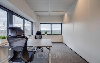 Bright office to rent at Zonnebaan 45 in Utrecht Lage Weide, featuring spacious desks by large windows with scenic views, ideal for office space rental.