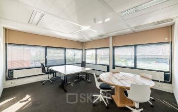 Bright, well-lit office space with modern furnishings and large windows located at Zonnebaan 45, Utrecht Lage Weide, showcasing a room available for office space rental.
