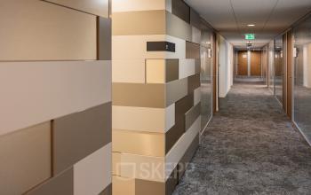 Hallway of an office building with modern beige and white wall design at Middenburcht 136, Utrecht Leidsche Rijn.