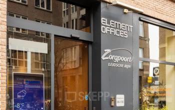 Exterior view of an office building located at Middenburcht 136 in Utrecht Leidsche Rijn, showcasing the main entrance with visible signage for office space rental.