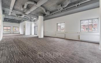 Spacious, unfurnished office interior at Goeman Borgesiuslaan 77, Utrecht North, ideal for office space rental with large windows and modern ceiling design.
