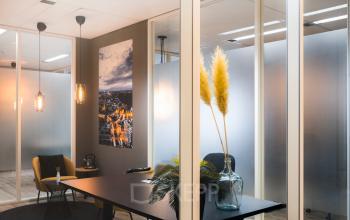 Sleek office space rental at Goeman Borgesiuslaan 77, Utrecht North, with modern furnishings and vibrant plant decor.