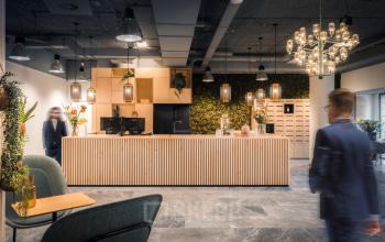 Modern office space rental at Goeman Borgesiuslaan 77, Utrecht North, with a stylish reception area and professionals engaged in business activities.