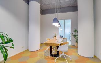 Office space rental at Goeman Borgesiuslaan 77, Utrecht Noord with a modern table, comfortable chairs, and chic lighting fixtures.