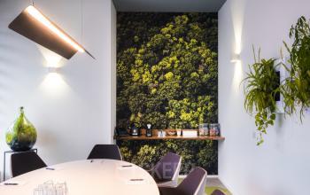 Modern office space rental at Goeman Borgesiuslaan 77, Utrecht North, featuring a contemporary conference room with a green living wall.