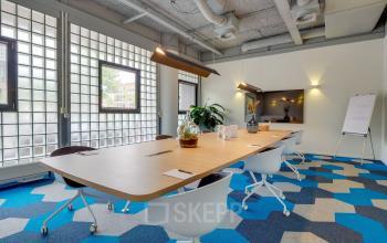 Modern Utrecht North office space rental at Goeman Borgesiuslaan 77 with vibrant carpet and chic furniture.