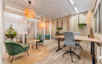 Modern office space rental at Goeman Borgesiuslaan 77 in Utrecht North with stylish furnishings, vibrant decor, and frosted glass partitions creating a bright, inviting workspace.