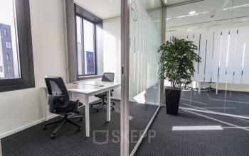 Modern office at Papendorpseweg 95-97, Utrecht Papendorp, featuring glass walls and ergonomic chairs, ideal for office space rental.