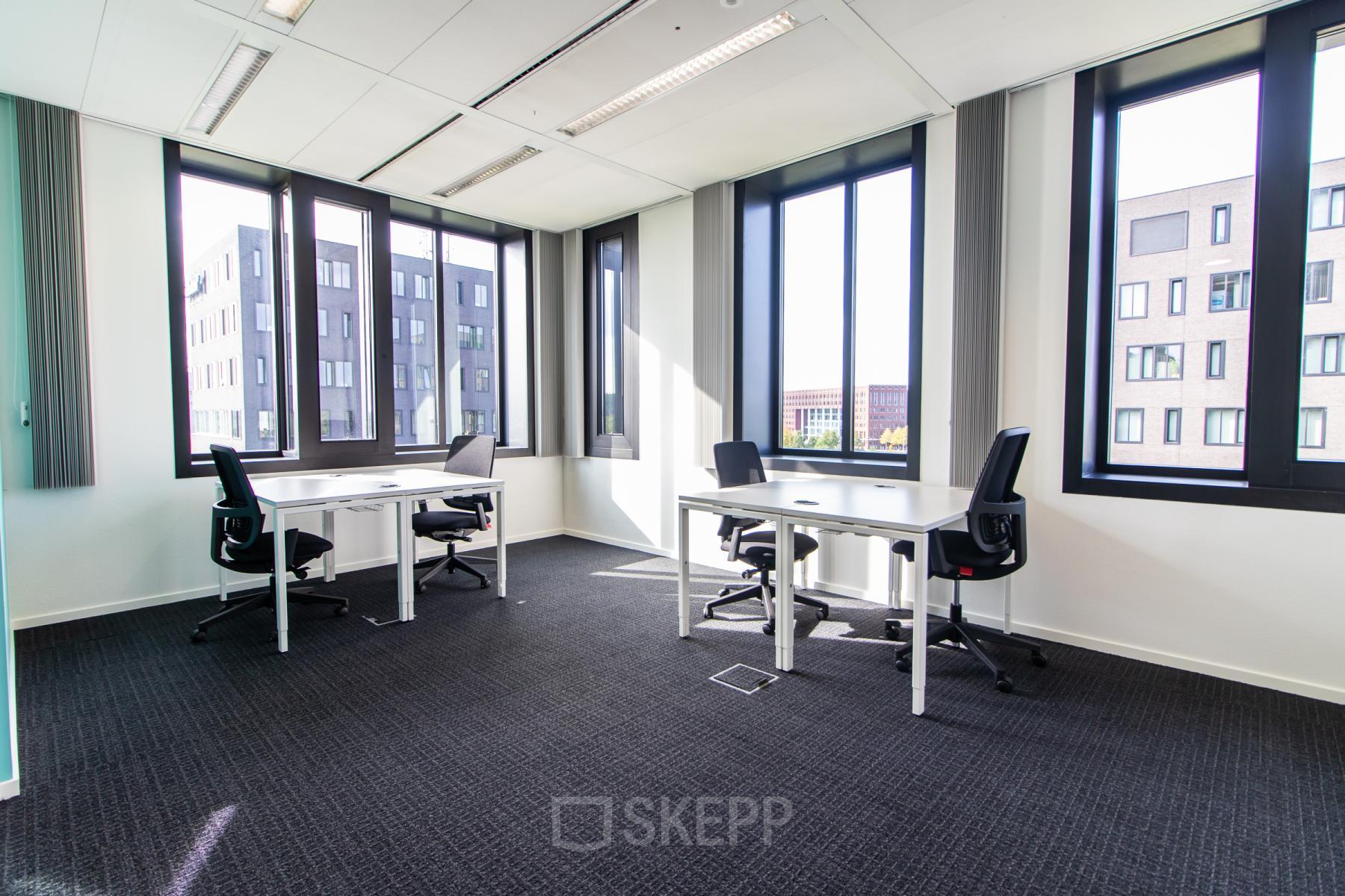 Bright office to rent at Papendorpseweg 95-97 in Utrecht Papendorp, featuring large windows and multiple desks. Ideal for office space rental with a modern work environment.