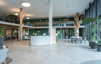 Modern office space for rent at Van Deventerlaan 31-51, Utrecht Papendorp, featuring a spacious and furnished interior with plants and seating areas, ideal for office space rental.
