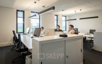 Bright, furnished office space at Van Deventerlaan 31-51, Utrecht Papendorp, featuring modern workstations and professionals collaborating. Ideal office space rental opportunity.
