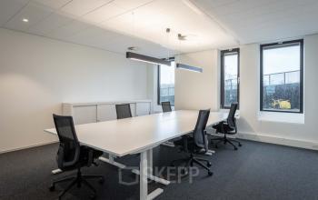 Spacious office space rental at Van Deventerlaan 31-51, Utrecht Papendorp, featuring a modern conference room with a large table and stylish chairs.