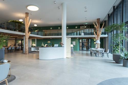 Modern office space for rent at Van Deventerlaan 31-51, Utrecht Papendorp, featuring a spacious and furnished interior with plants and seating areas, ideal for office space rental.