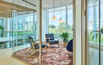 Furnished office space at Van Deventerlaan 30-40, Utrecht Papendorp, featuring modern chairs and a glass partition with natural lighting.