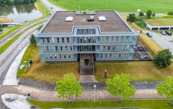 Aerial view of a contemporary office space rental at Orteliuslaan 850, in Utrecht Papendorp, showing exterior with surrounding green spaces.