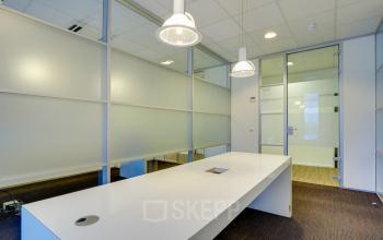 Modern reception area at Orteliuslaan 850 offering office space rental in Utrecht Papendorp with a sleek white desk and pendant lighting.
