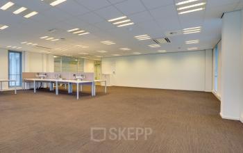 Spacious, well-lit office space rental at Orteliuslaan 850, Utrecht Papendorp, containing neat desks and ample floor area.