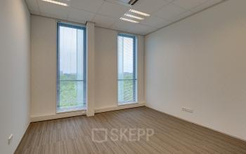 Modern office space rental at Orteliuslaan 850, Utrecht Papendorp featuring large windows and neutral tones.