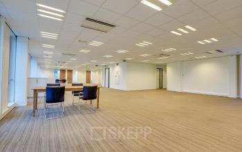 Modern office space rental at Orteliuslaan 850, Utrecht Papendorp, featuring a well-lit room with desks and chairs.