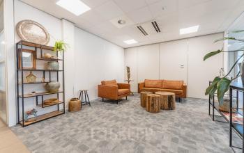 Furnished office space at Orteliuslaan 850, Utrecht Papendorp, featuring leather sofas and rustic decor for a cozy workspace. Ideal for rent office space seekers.
