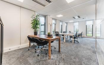 Interior view of a furnished office at Orteliuslaan 850, Utrecht Papendorp, featuring multiple desks and chairs, available for office space rental.