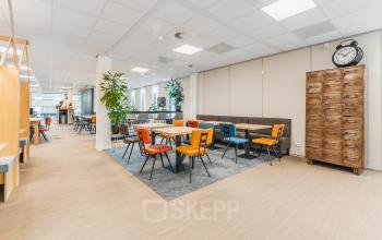 Bright and modern office space at Orteliuslaan 850, Utrecht Papendorp, featuring colorful seating and ample natural light, ideal for office space rental.