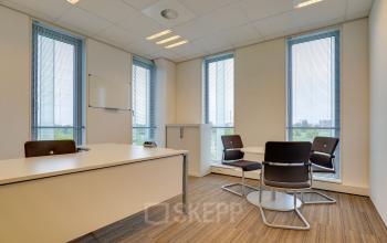Bright office space rental at Orteliuslaan 850 in Utrecht Papendorp with large windows and a modern meeting table setup.