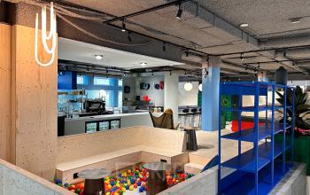 A vibrant office space with a play area featuring colorful balls and a lounge area with modern seating at Daltonlaan 200, Utrecht Rijnsweerd, ideal for office space rental.