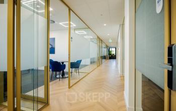 Modern office space with glass walls and wood flooring at Euclideslaan 51, Utrecht Rijnsweerd, perfect for office space rental. Bright and contemporary design enhances the professional environment.