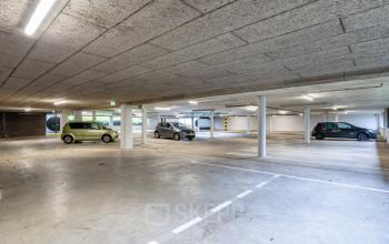 Spacious underground parking area at Euclideslaan 51, Utrecht Rijnsweerd, perfect for office space rental. The well-lit facility offers convenient parking spots for employees and visitors.