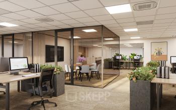 Modern office space at Newtonlaan 115 in Utrecht Rijnsweerd, featuring open workstations, a glass-enclosed conference room, and lush greenery.