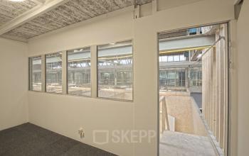 Interior view of an unfurnished office space with large windows at Eendrachtlaan 100-260, Utrecht South, suitable for office space rental.