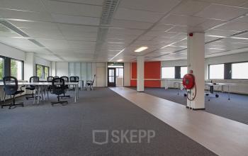 Spacious and well-lit office space rental at Winthontlaan 200, in Utrecht South, with desks and chairs set for business activities.
