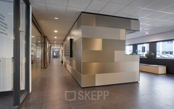Spacious and well-lit corridor inside the office space rental at Winthontlaan 200, Utrecht Zuid, with modern angular reception desk.