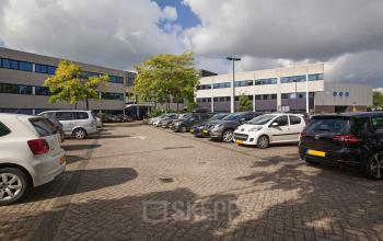 Well-maintained office space rental at Winthontlaan 200 in Utrecht South, with a parking area in the foreground and modern office buildings in the background.