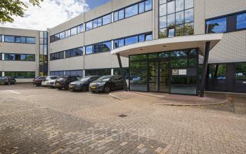 Exterior view of the office space rental at Winthontlaan 200, Utrecht South, with a parking area in front.