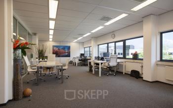 Spacious, well-lit office space with large windows, modern furniture, and decor, located at Winthontlaan 200, Utrecht South, offering an excellent office space rental option.