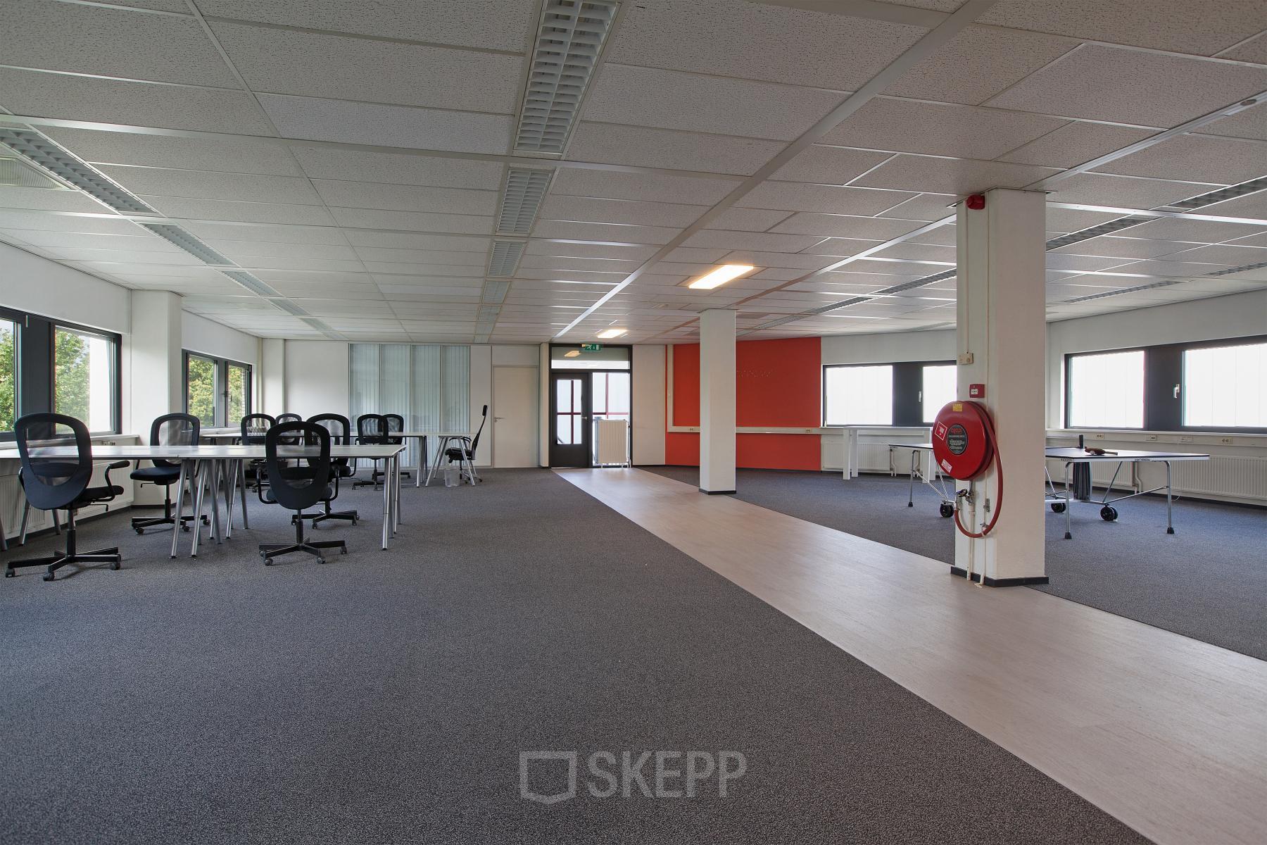 Spacious and well-lit office space rental at Winthontlaan 200, in Utrecht South, with desks and chairs set for business activities.