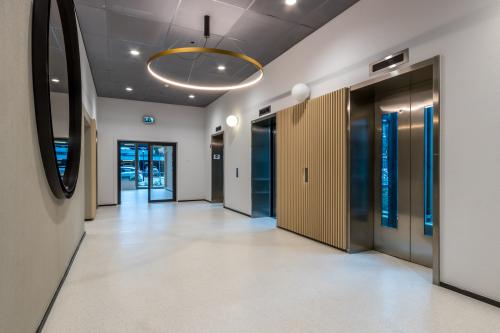 Spacious and modern office entrance with elevators and sleek design, ideal for those looking to rent office space in Utrecht South.