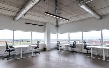 Modern office space at Churchilllaan 11, Utrecht South, featuring large windows and multiple workstations ideal for office space rental.