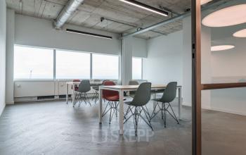 Modern, well-lit office space rental at Churchilllaan 11, Utrecht South, featuring a contemporary design with stylish furniture and ample lighting.