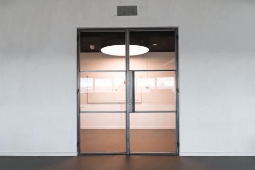 Modern office entrance at Churchilllaan 11, Utrecht South, featuring sleek glass doors and minimalist design ideal for office space rental inquiries.