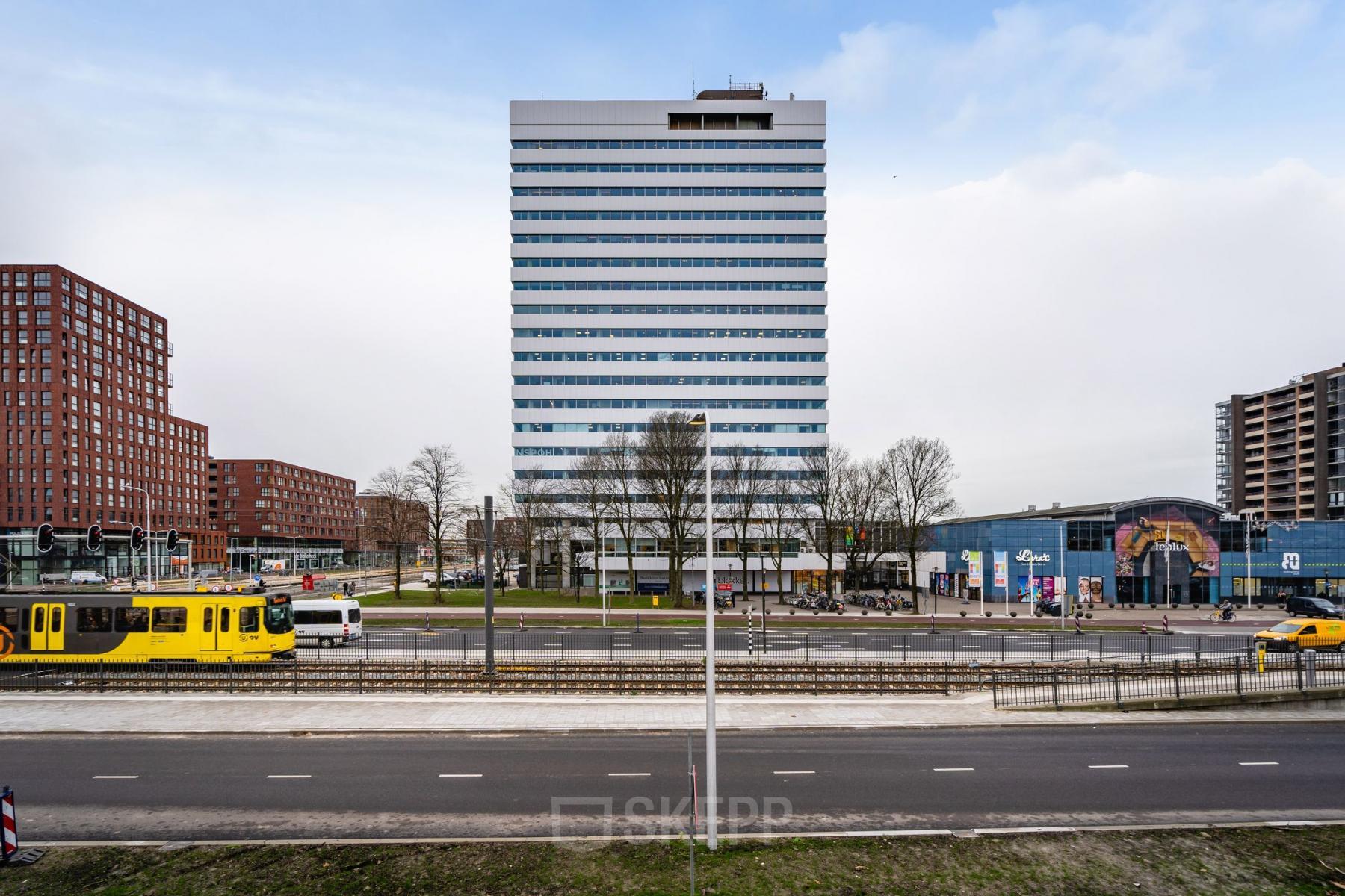 Exterior view of the office building at Churchilllaan 11, Utrecht South, featuring a modern high-rise suitable for office space rental, surrounded by city streets and public transportation access.