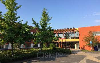 Exterior view of the office building located at Kerkhofstraat 21, Valkenswaard, featuring modern architecture with landscaped surroundings.