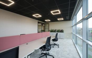 Modern office space at Doornhoek 3745, Veghel, featuring sleek workstations with ergonomic chairs and large windows for natural light, ideal for office space rental.